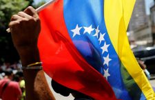 FILE PHOTO: A supporter of Venezuela's President Nicolas Maduro holds a Venezuelan flag during the May Day celebrations in Caracas, Venezuela May 1, 2022. REUTERS/Leonardo Fernandez Viloria/File Photo